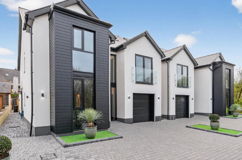 a house with a black and white facade at Ty Hir in Llanelli