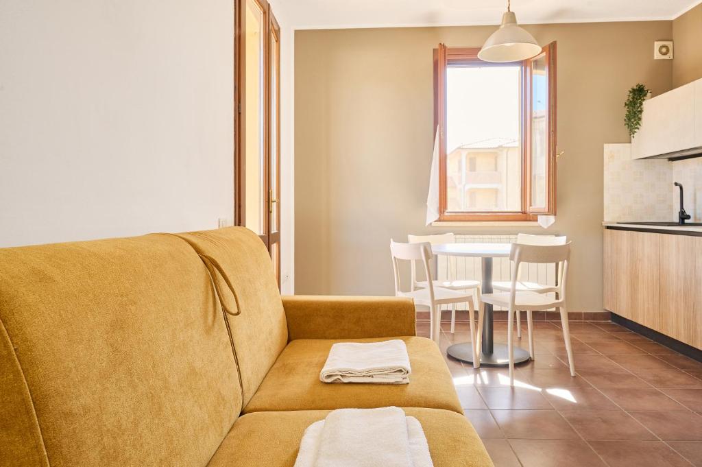a living room with a couch and a table at Casa La Polledraia in Venturina Terme