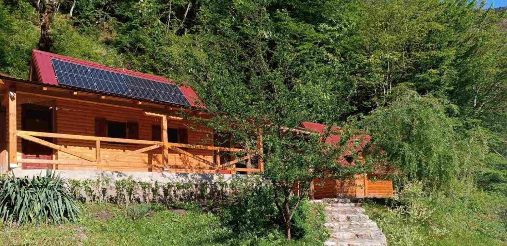 a house with solar panels on top of it at Wildas Cabins, Tara River Canyon in Foča