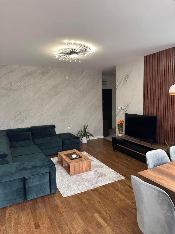 a living room with a couch and a coffee table at New Bubanj Apartment 3 in Kragujevac