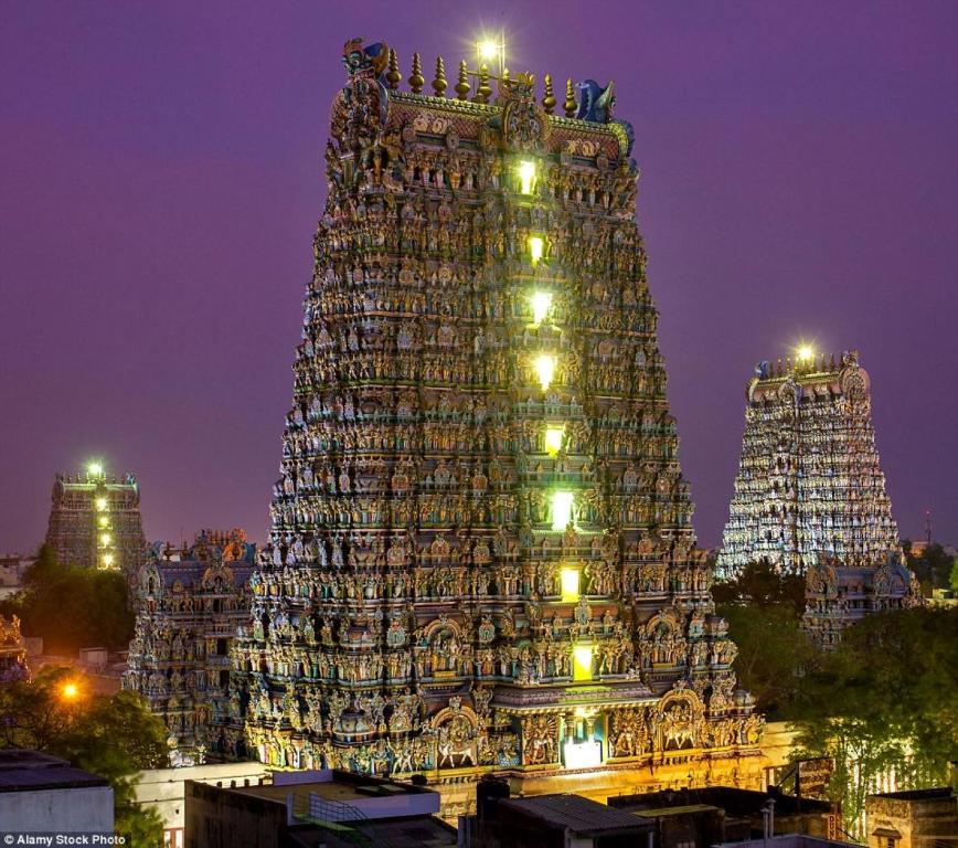 a large building with a christmas tree at night at La Vonto - Madurai Railway Junction in Madurai