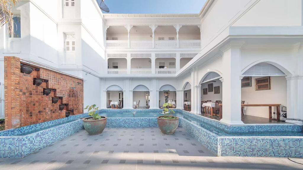 a large building with blue tiles on the floor at Lanna Inthan Hotel & Resort in Doi Saket