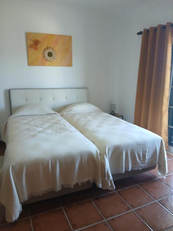 two beds sitting next to each other in a room at Casa FIGUEIRAS in Bensafrim