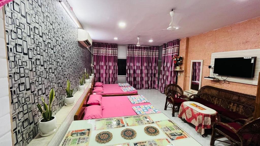 a living room with two tables and a couch at Marble Man Homestay in Agra