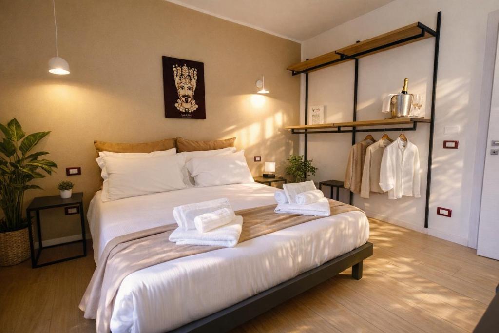 a bedroom with a large bed with towels on it at Noor Palace - PI Collection Hotel in Palermo