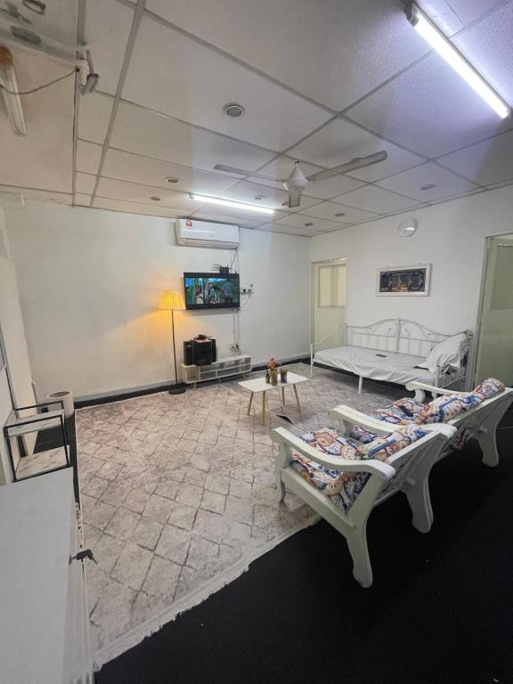 a large room with two beds and a table at Sejiwo Apartment 6-8pax in Pengkalan Cepa