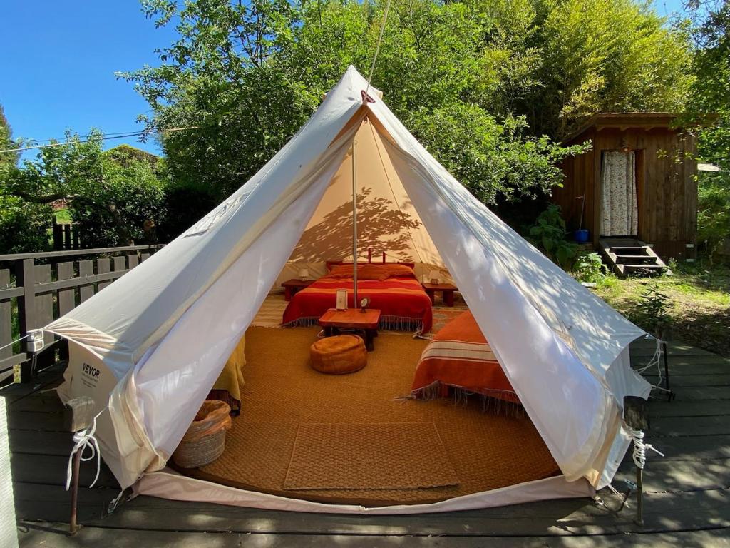 a teepee tent with a bed in a backyard at Podere di Maggio - Glamping tent 3 in Santa Fiora