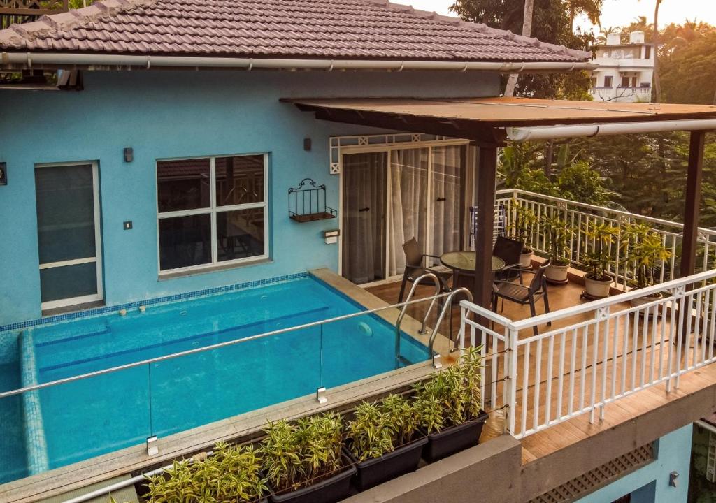 a house with a swimming pool on a balcony at Beach 7 mins walk Luxury villa Diva in Calangute