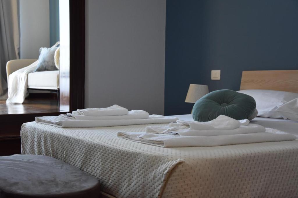 a bedroom with a bed with white towels on it at Thalore room e apartments in Amantea