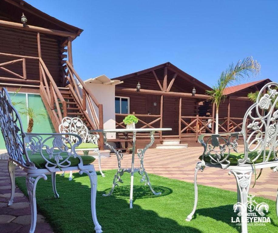 a group of chairs sitting in front of a house at Hotel La Leyenda Sonora in El Saucito