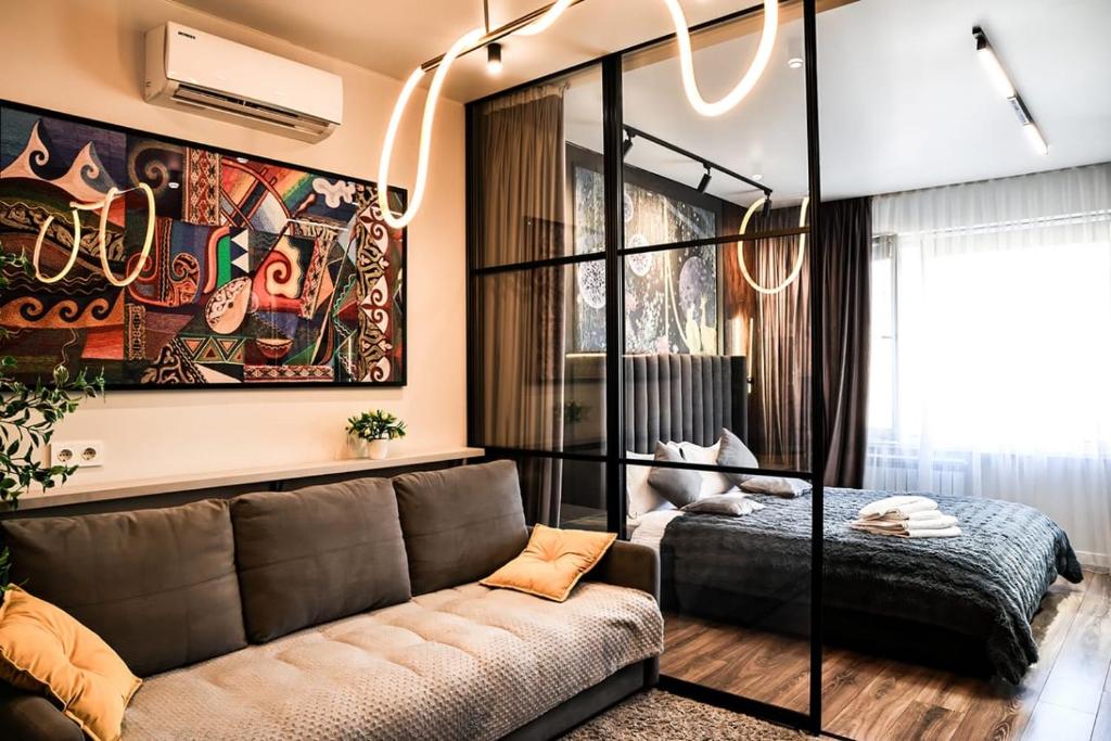 a living room with a couch and a bed at Auezov City in Almaty