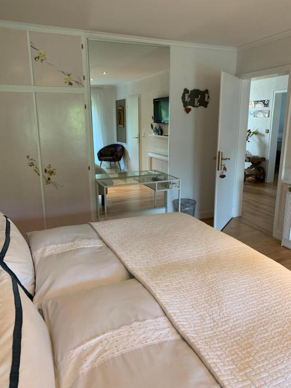 a living room with a bed and a glass table at Comfort Doppelzimmer mit Balkon und Blick ins Grüne in Mespelbrunn