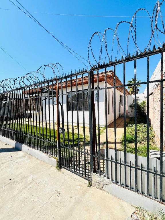 a fence with barbed wire in front of a house at Departamento Independiente Altavista Hostal- 6 personas in Rancagua