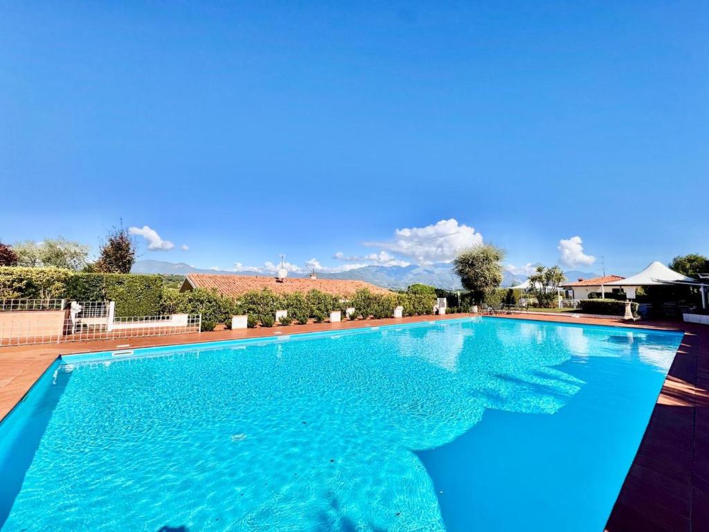 a large swimming pool with blue water at Residence agli Oleandri in Manerba del Garda