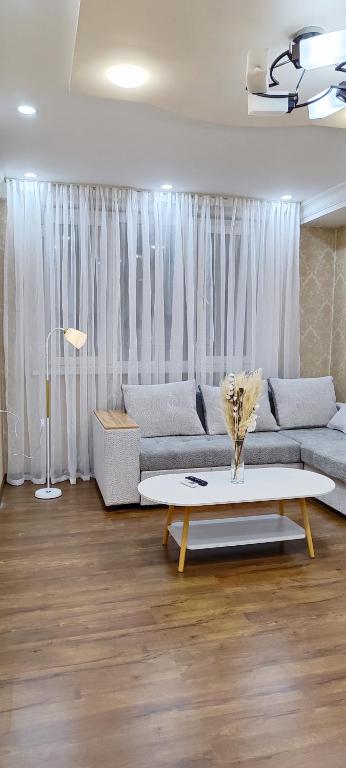a living room with a couch and a table at Old Town Apartment in Tashkent