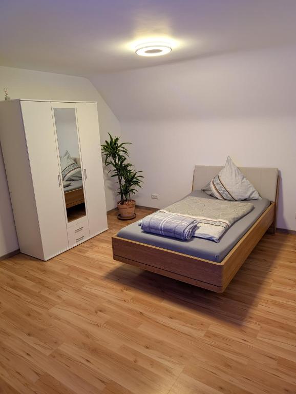 a bedroom with a bed and a mirror in it at Google Smart Home Unterkunft - 1 in Kenn