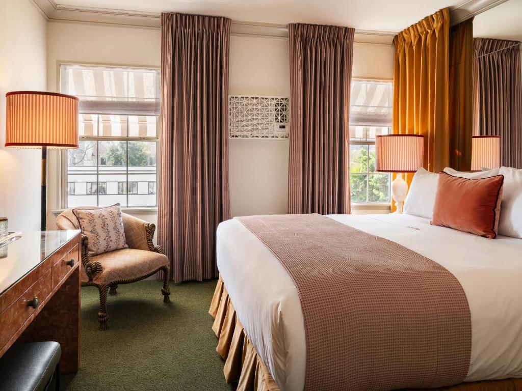 a hotel room with a bed and a chair and a window at The Hotel Lili in Los Angeles