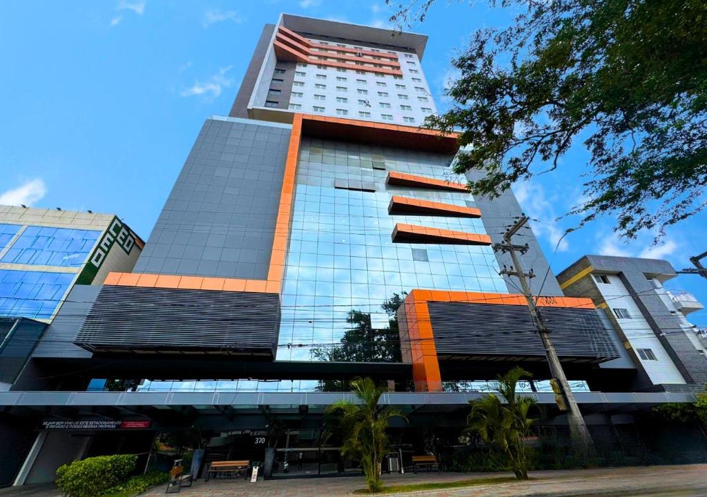 a tall building with a lot of windows at Nord Luxxor Citymix in Campina Grande