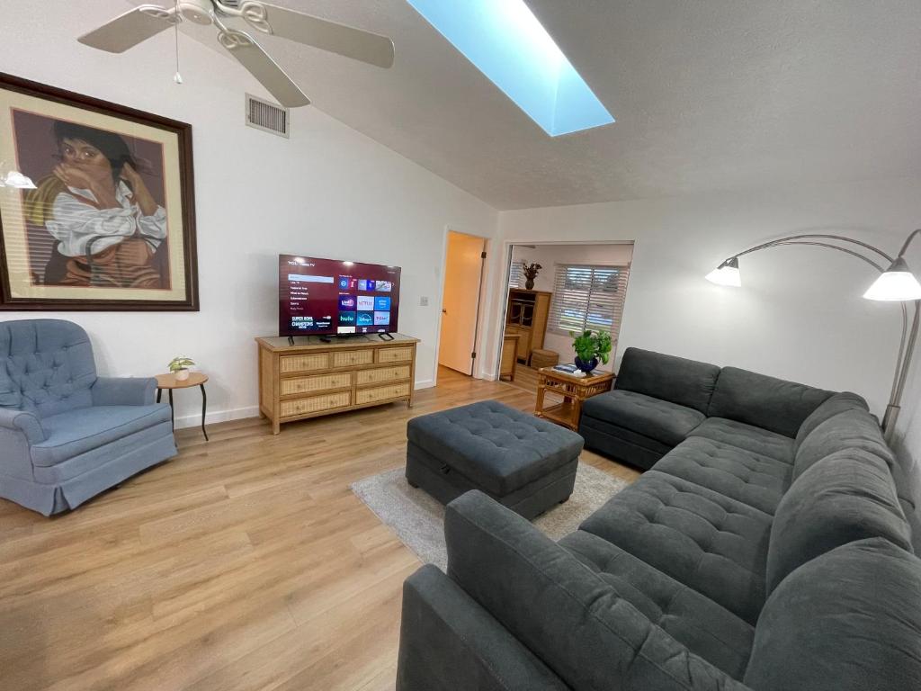 a living room with a couch and a tv at Stylish budget friendly retreat! in Lake Placid