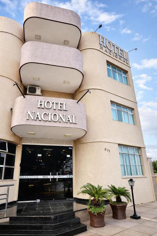 a hotel national with plants in front of it at Hotel Nacional Service - Fácil acesso a Região da 44 e Rodoviária in Goiânia