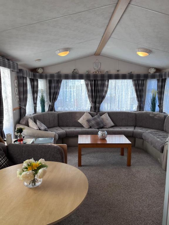 a living room with a couch and a table at Cocos haven in Ballantrae