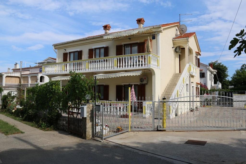 a house with a white fence in front of it at Apartment in Silo with Two-Bedrooms 7 in Šilo