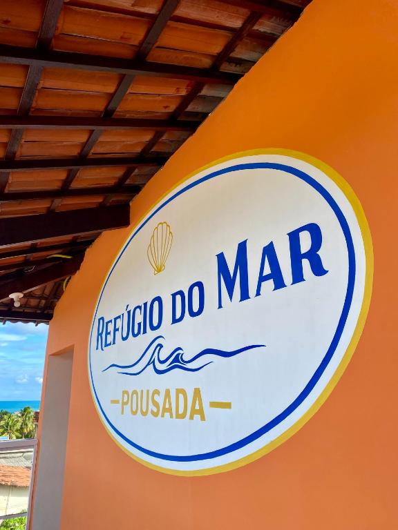 a sign for a maruca do mar on an orange wall at Refúgio do Mar in Nísia Floresta