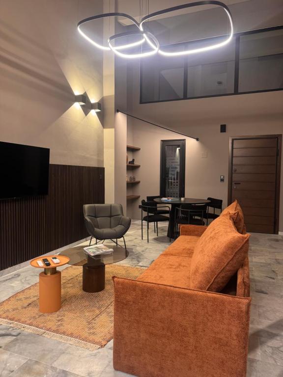 a living room with a couch and a table at The 9 loft in Pyrgos
