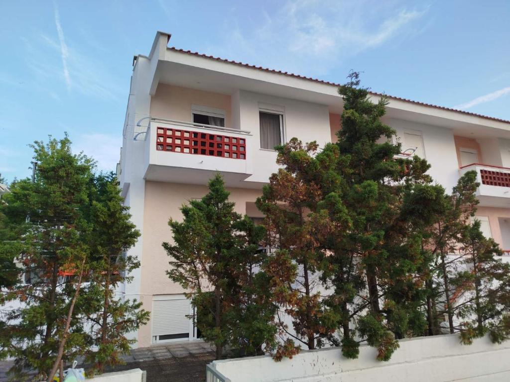 a white house with trees in front of it at Villa Estrella - Pool - Sunset Views - 200m Siviri Beach in Siviri