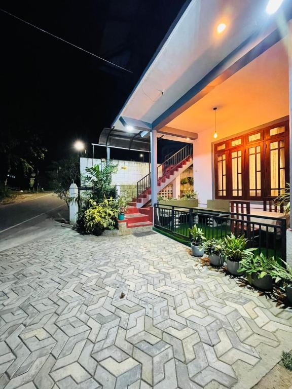 a house with a stone patio in front of it at Rich Grove Inn in Ella