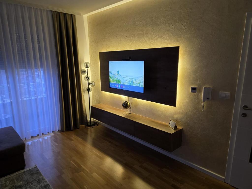a living room with a flat screen tv on a wall at ENA Lux in Novi Pazar