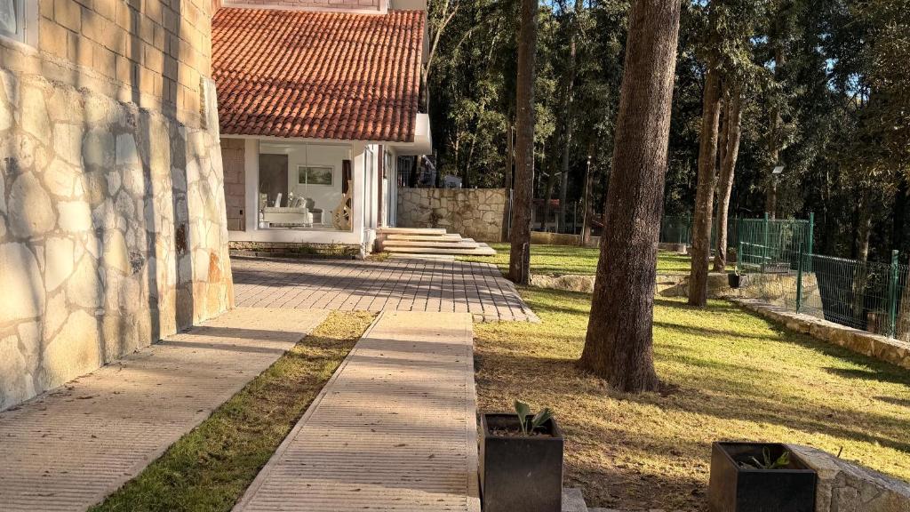 a house with a walkway in front of a yard at Villa 1 TRES SENDEROS in Omitlán de Juárez