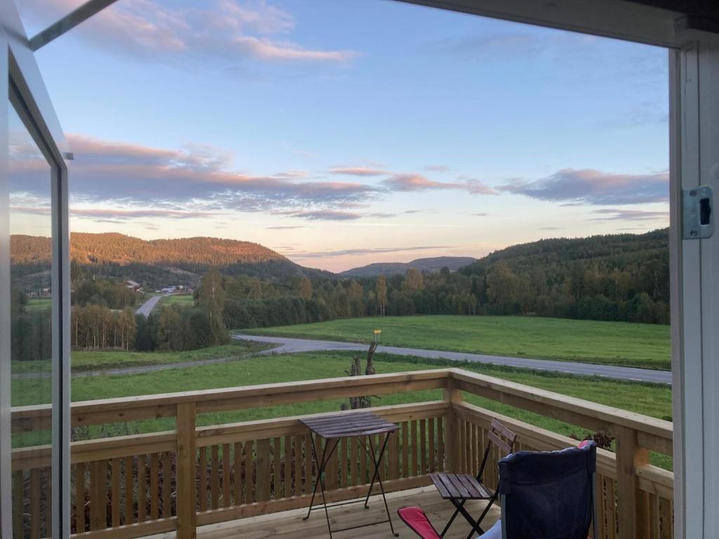 a balcony with chairs and a view of a river at Maple Cottage in Docksta