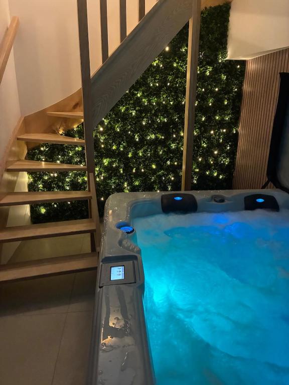 a swimming pool next to a staircase with a christmas tree at Duplex with Jacuzzi - Grand place Arras in Arras