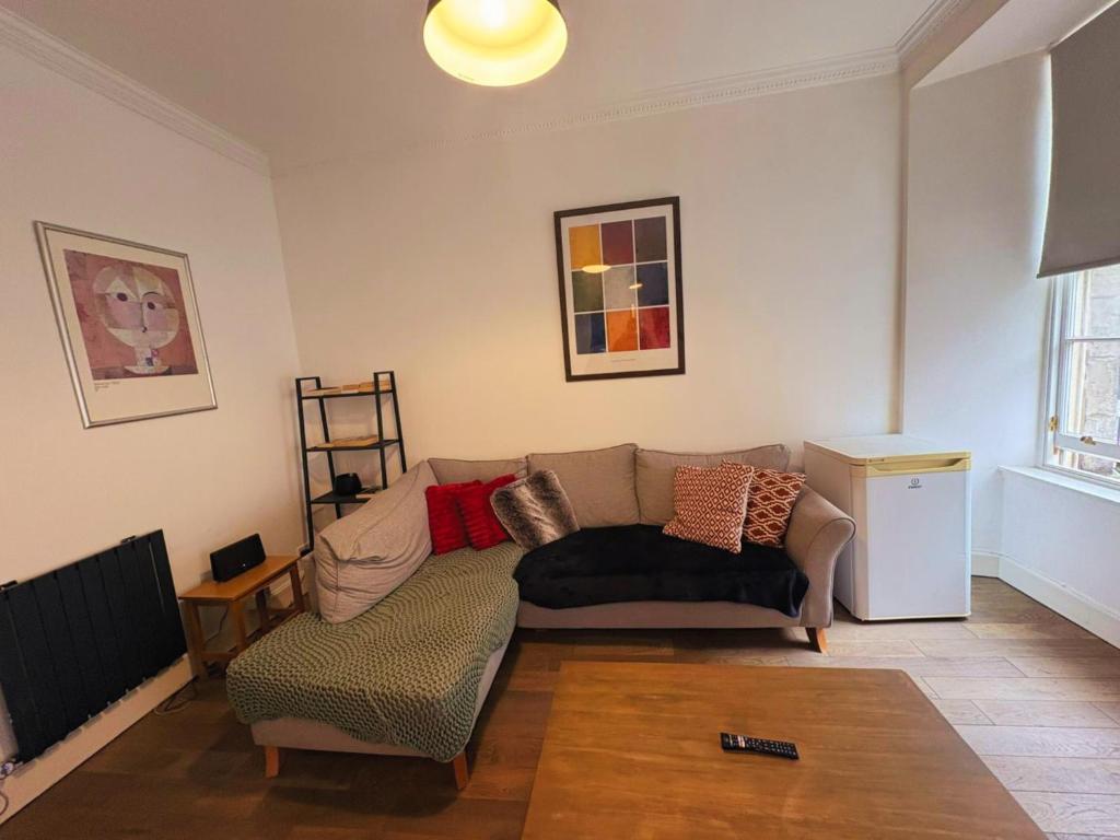 a living room with a couch and a chair at Edinburgh Town Apartment in Edinburgh