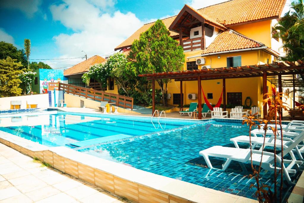 a swimming pool in front of a house at Pousada Granville in Campina Grande