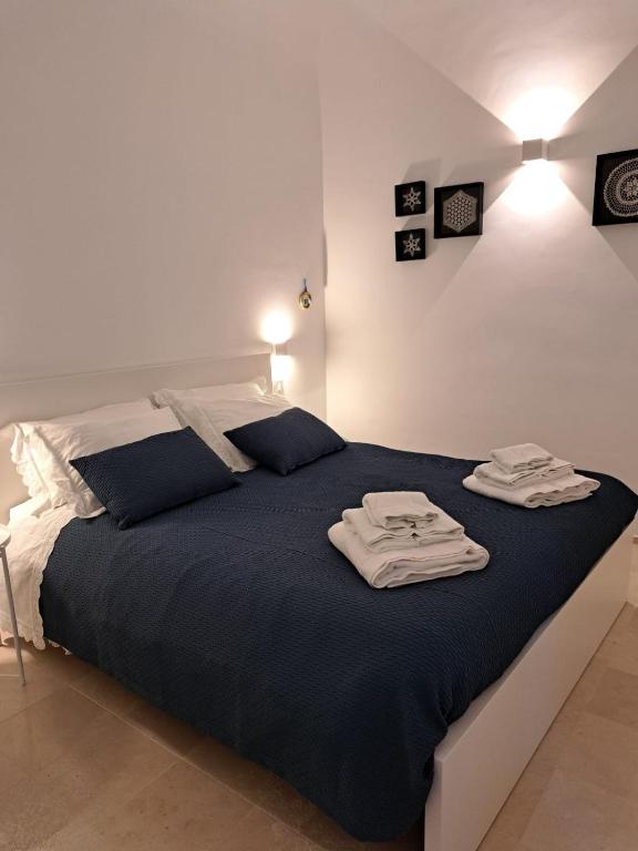 a bedroom with a bed with two towels on it at Dimora Veneziani in Bisceglie