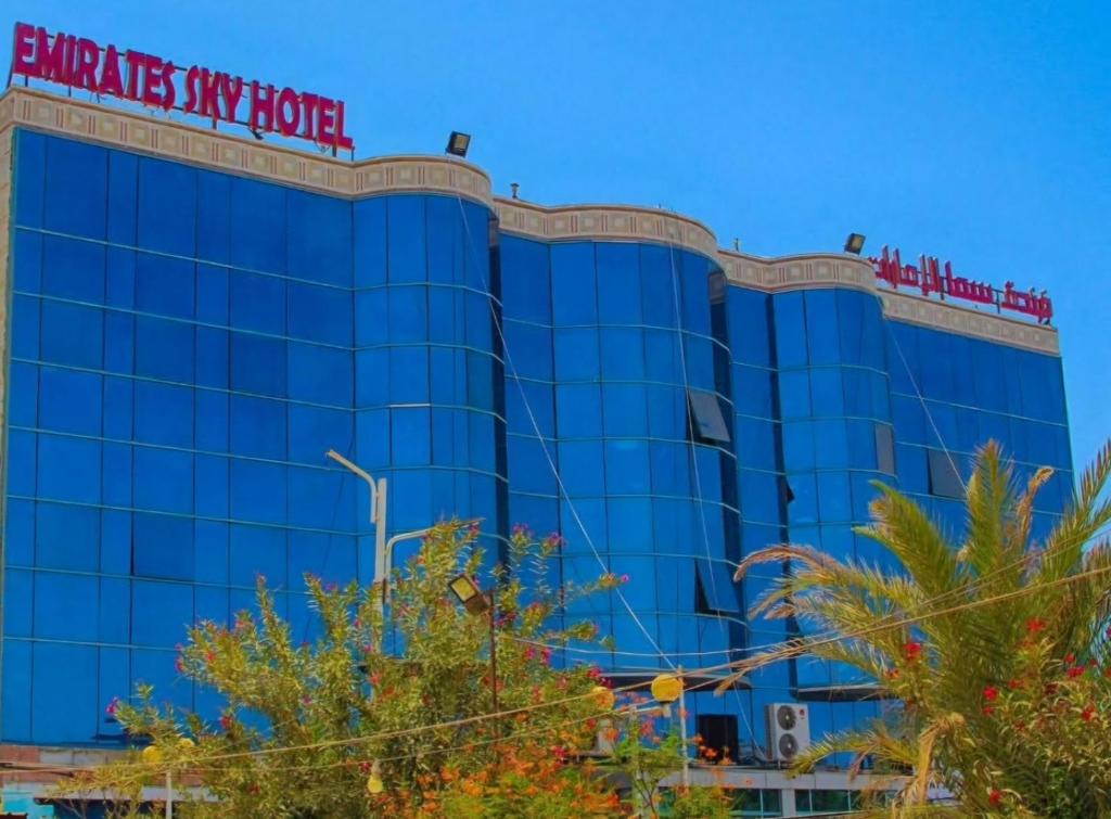 a blue building with a sign on it at فندق سماء الإمارات in Khawr Maksar