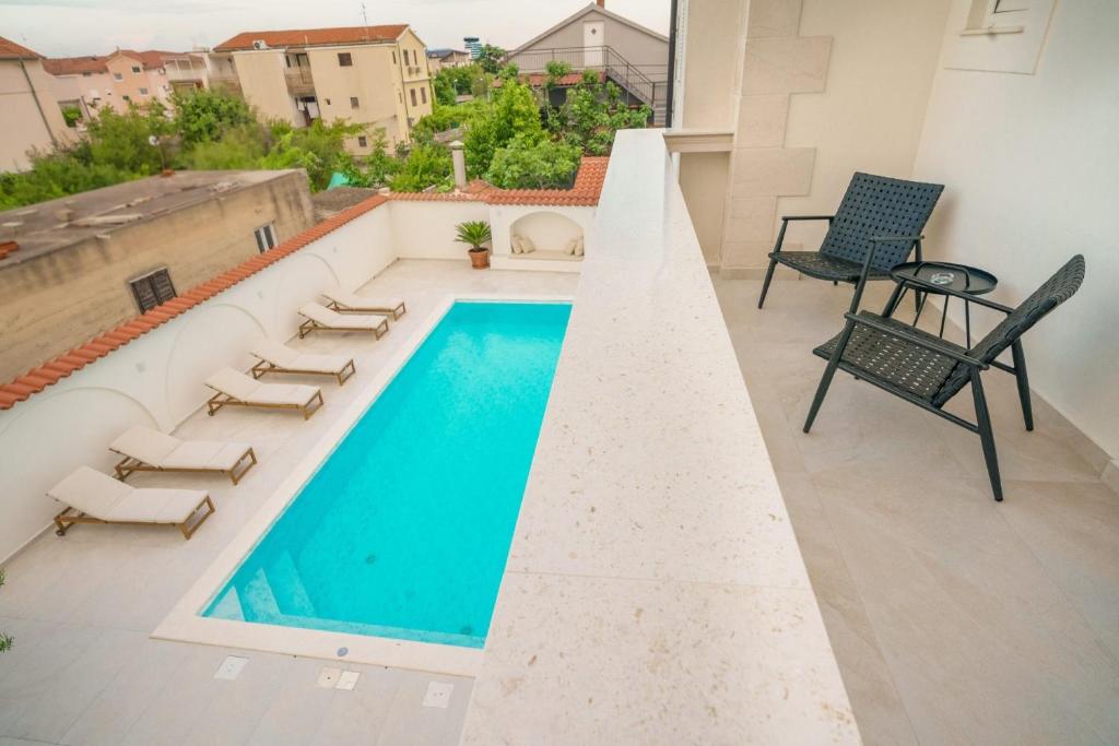 a swimming pool on the roof of a building at Apartments Bianca Vodice in Vodice