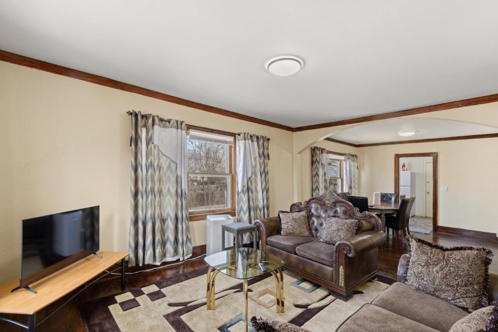 a living room with a couch and a television at College Area 3BR in Grand Rapids