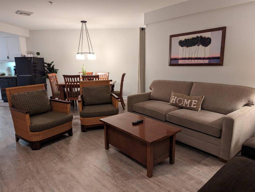 a living room with a couch and chairs and a table at Premium New 1bd Sunset balcony 3rd flr in Vernon Township