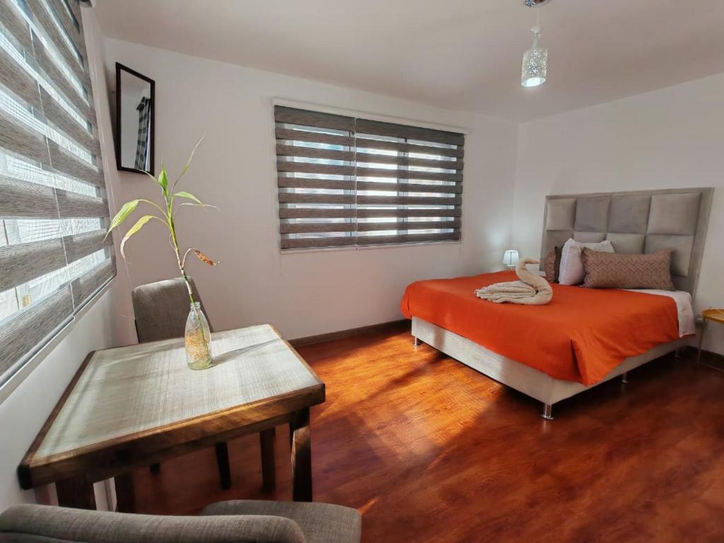a bedroom with a bed and a table in it at York Hostel in La Paz