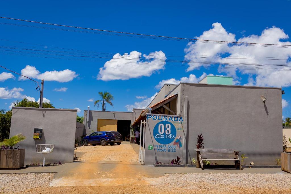 a building with a sign on the side of it at Pousada Zero Três - 03 in Chapada dos Guimarães