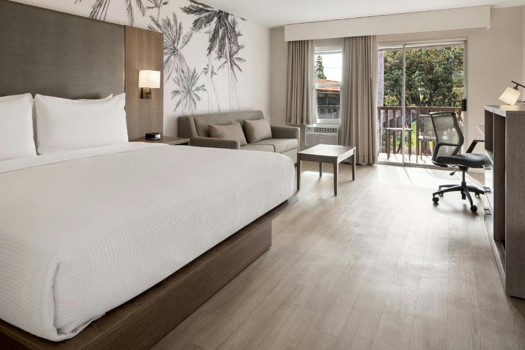 a hotel room with a bed and a living room at FOUND Hotels, Santa Barbara, Series by Marriott in Santa Barbara