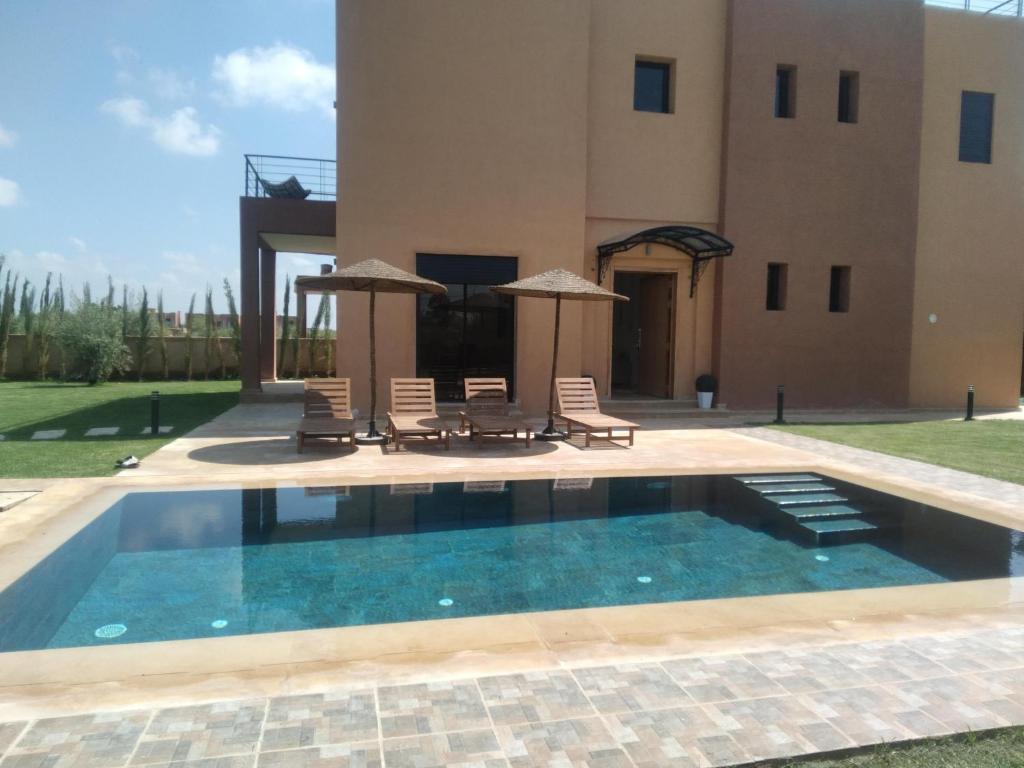 a swimming pool in front of a villa at Villa Dar Daraa with Pool in Najem