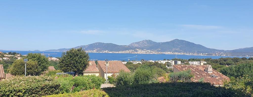 a town with a view of the water and mountains at Beautiful 40 M2 With Pool Near The Beach! in Grosseto-Prugna