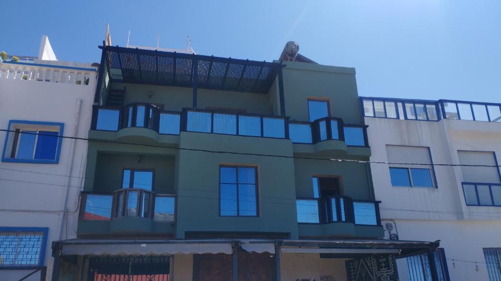 a building with a balcony on the side of it at chillax see view terrace in Imsouane