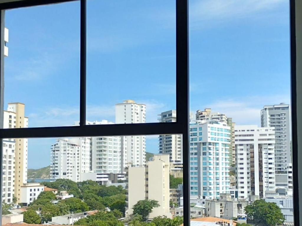 a view of a city skyline from an office window at Apartamento en el Rodadero, a pocos metros de la playa in Gaira
