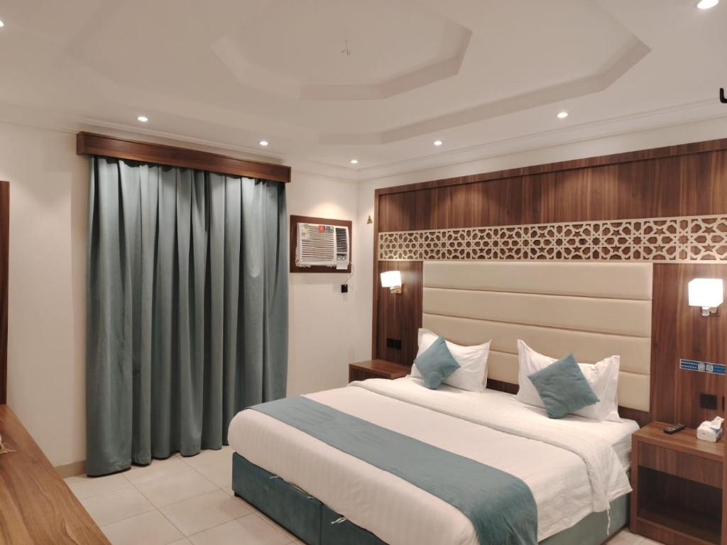 a bedroom with a large bed in a room at ROOM - Alwazirya in Jeddah