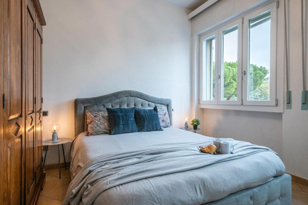 a bedroom with a large bed with a dog laying on it at Mandela Stadium Apartment in Florence